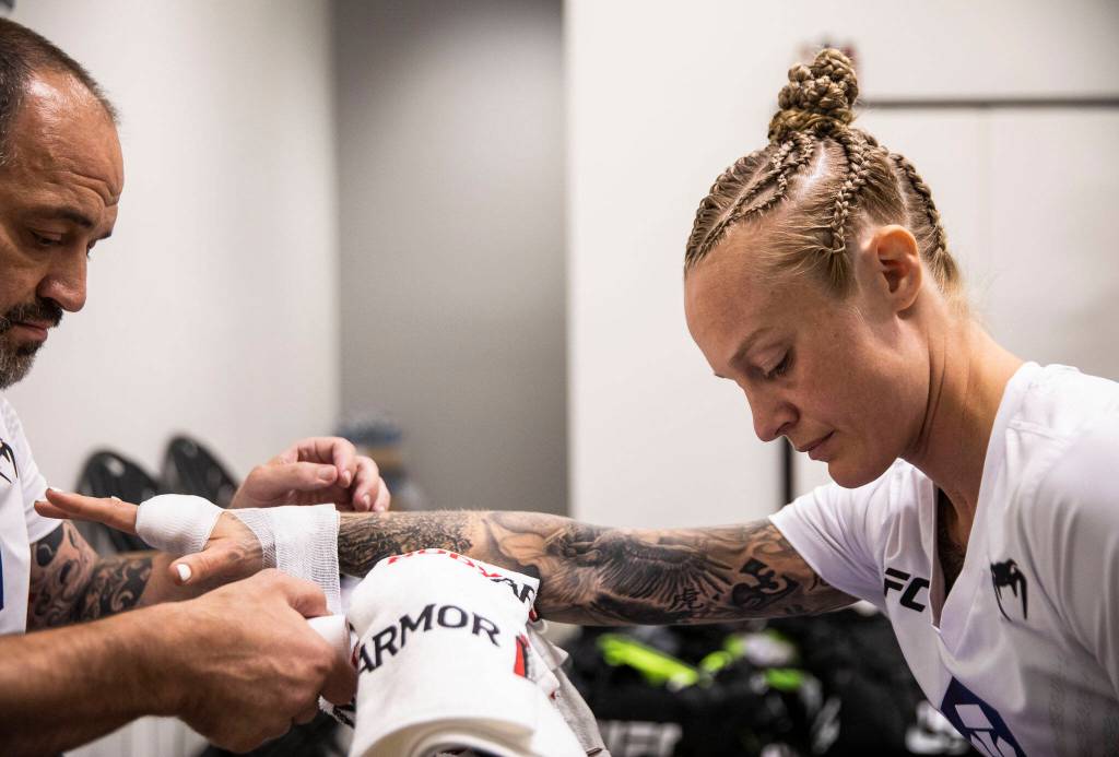 Coach and lead corner Charlie Pearson, left, wraps Miranda Grangers hands before her fight at the UFC Apex on Aug. 6, 2022, in Las Vegas. Pearson has been Grangers coach since she was 4 years old. He has wrapped her hands before all of her professional fights. (Olivia Vanni / The Herald)
