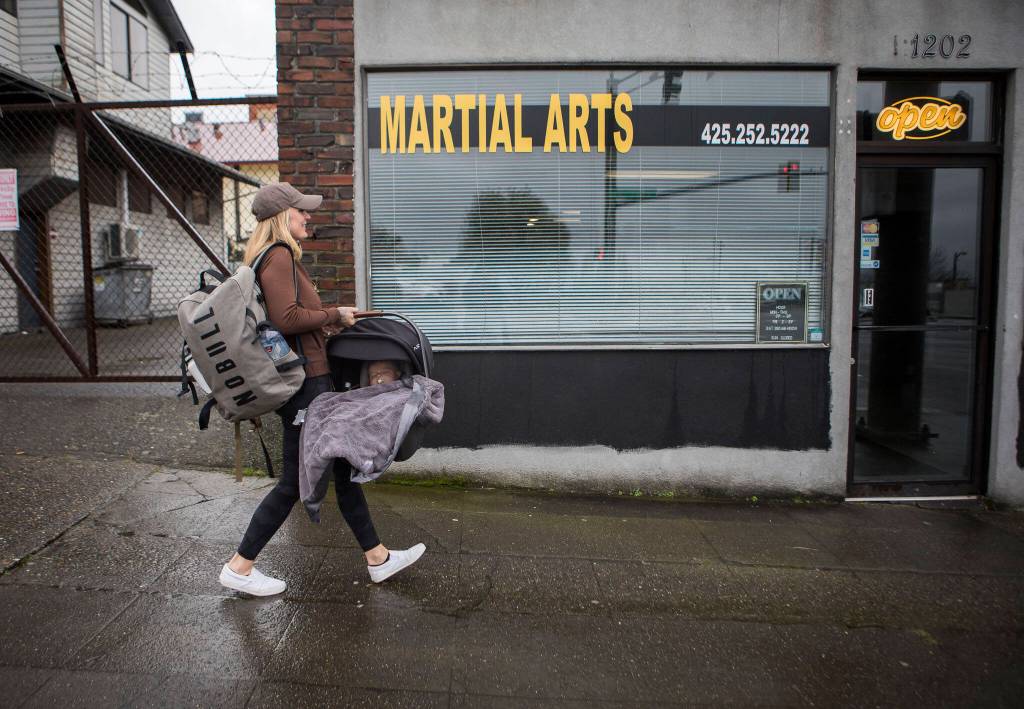 Austin sleeps while her mother Miranda Granger carries her into Charlies Combat Club on Monday, Feb. 28, 2022, in Everett, Washington. (Olivia Vanni / The Herald)