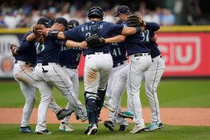 Seattle Mariners players dance as they celebrate their 4-3 win over the New York Yankees in a baseball game, Wednesday, Aug. 10, 2022, in Seattle. (AP Photo/Ted S. Warren)
