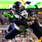 Seattle Seahawks running back DeeJay Dallas (31) leaps to the end zone for a touchdown as Pittsburgh Steelers linebacker Buddy Johnson (45) hits him during the second half of a preseason game Saturday in Pittsburgh. (AP Photo/Barry Reeger)