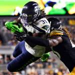 Seattle Seahawks running back DeeJay Dallas (31) leaps to the end zone for a touchdown as Pittsburgh Steelers linebacker Buddy Johnson (45) hits him during the second half of an NFL preseason football game Saturday, Aug. 13, 2022, in Pittsburgh. (AP Photo/Barry Reeger)