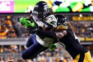 Seattle Seahawks running back DeeJay Dallas (31) leaps to the end zone for a touchdown as Pittsburgh Steelers linebacker Buddy Johnson (45) hits him during the second half of an NFL preseason football game Saturday, Aug. 13, 2022, in Pittsburgh. (AP Photo/Barry Reeger)