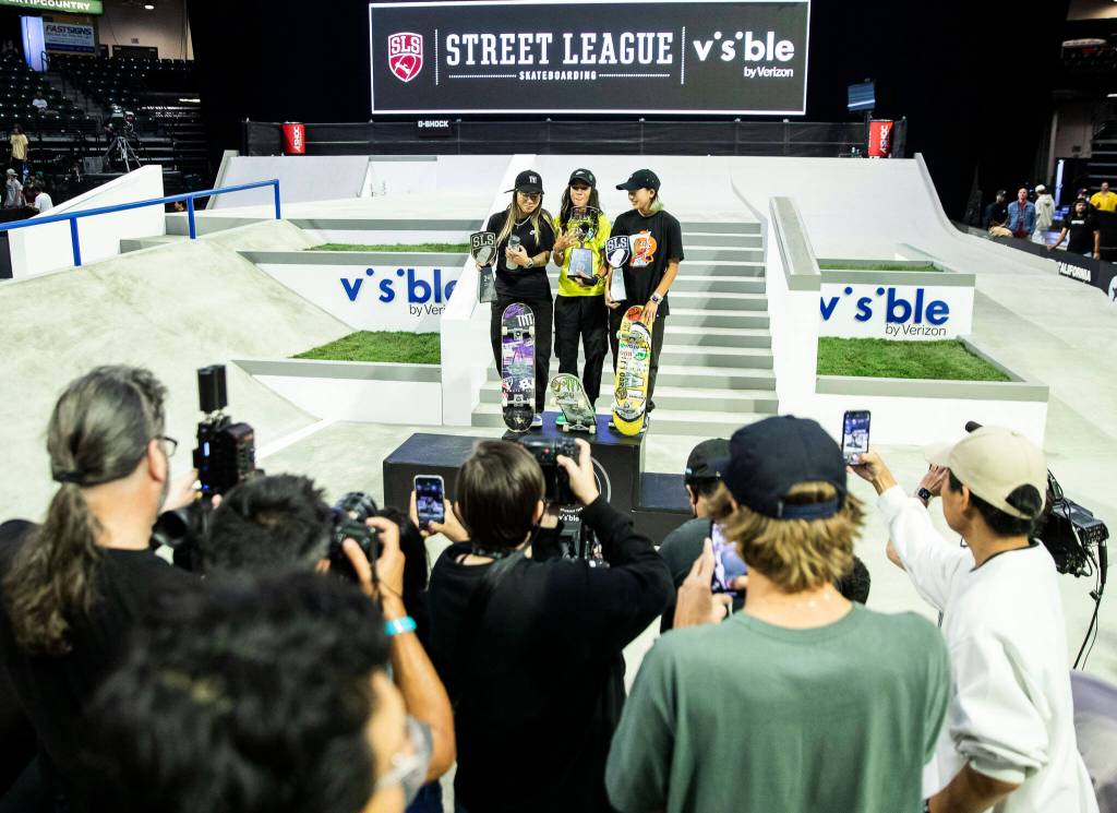 Pamela Rosa, Rayssa Leal and Yuemka Oda hold their respective trophies after the Street League Skateboarding womens final on Sunday, Aug. 14, 2022 in Everett, Washington. (Olivia Vanni / The Herald)