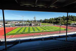 People explore Everett Memorial Stadium’s new turf and track during an open house event Monday, Aug. 15, 2022, in Everett, Washington. (Ryan Berry / The Herald)