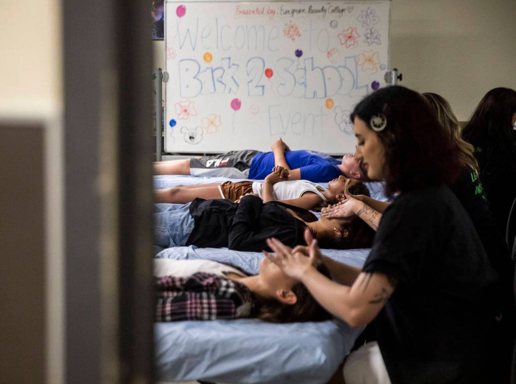 People get facials during Evergreen Beauty Colleges annual back-to-school beauty event on Wednesday, in Everett. (Olivia Vanni / The Herald)
