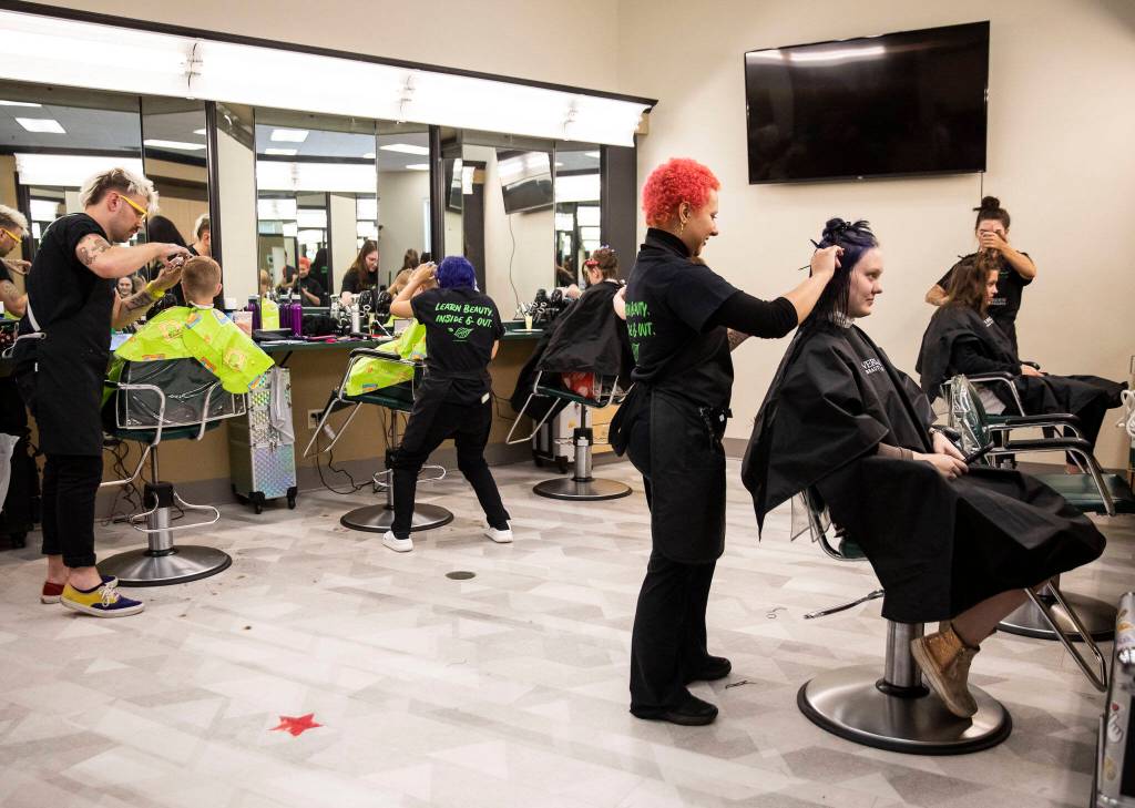 People get their hair cut during Evergreen Beauty Colleges annual back-to-school beauty event on Wednesday, in Everett. (Olivia Vanni / The Herald)