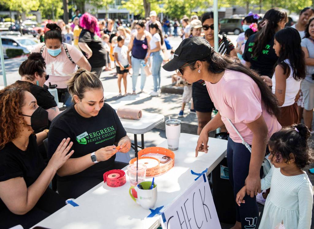 People line up for the Evergreen Beauty Colleges annual back-to-school beauty event on Wednesday, in Everett. (Olivia Vanni / The Herald)