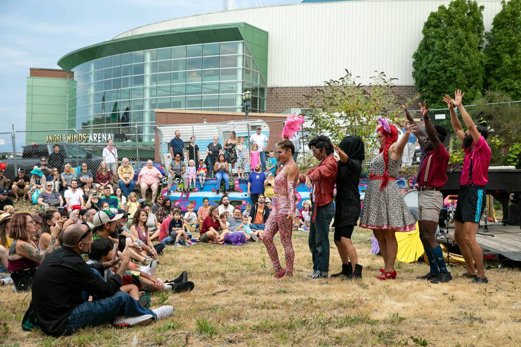 The Up Up Up performers introduce themselves during their evening circus performance Friday, in the empty lot at Hewitt and Oakes in downtown Everett. (Ryan Berry / The Herald)