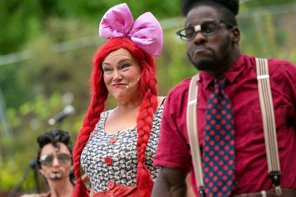 Performers enter the stage during Up Up Up Crane Circus evening performance Friday, in the empty lot at Hewitt and Oakes in downtown Everett. (Ryan Berry / The Herald)