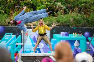 Performers show off their mop talents during Up Up Up Crane Circus’ evening performance Friday, Aug. 19, 2022, in the empty lot at Hewitt and Oakes in downtown Everett, Washington. (Ryan Berry / The Herald)