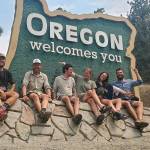 Pacific Crest Trail hikers pose in front of the Oregon Welcomes You sign after crossing into Oregon from California. (The Oregonian)