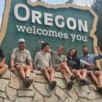 Pacific Crest Trail hikers pose in front of the Oregon Welcomes You sign after crossing into Oregon from California. (The Oregonian)