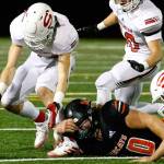 Snohomish's Kaden Alexander gathers a loose ball from a punt Friday night at Monroe High School on October 22, 2021.  (Kevin Clark / The Herald)