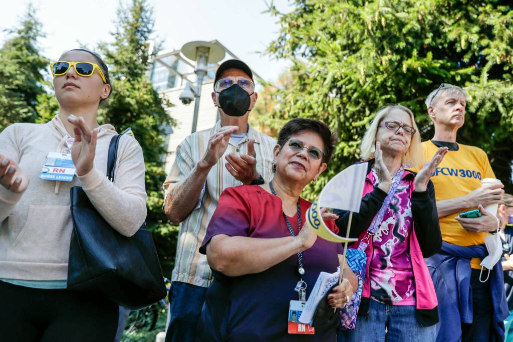 Supporters and staffer members gather to support the call for better working conditions at Providence Medical Center Wednesday afternoon, in Everett. (Kevin Clark / The Herald)