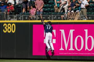 Seattle Mariners rightfielder Mitch Haniger cannot get to a homerun ball hit by Washington Nationals' Ildemaro Vargas during the ninth inning of a baseball game, Wednesday, Aug. 24, 2022, in Seattle. (AP Photo/Stephen Brashear)