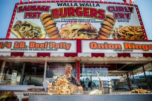 Onions are grilled up at the Walla Walla Burger booth during opening day of the Evergreen State Fair on Thursday, Aug. 25, 2022 in Monroe, Washington. (Olivia Vanni / The Herald)