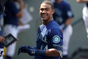 Seattle Mariners' Julio Rodriguez smiles in the dugout after his three-run home run against the Texas Rangers during the seventh inning of a baseball game Wednesday, July 27, 2022, in Seattle. The Mariners won 4-2. (AP Photo/Ted S. Warren)