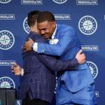 Seattle Mariners' Julio Rodriguez hugs Mariners President of Baseball Operations Jerry Dipoto at the end of a news conference held a day after announcing he signed a multi-year contract, Saturday, Aug. 27, 2022, in Seattle. (AP Photo/John Froschauer)