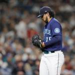 Seattle Mariners relief pitcher Andres Munoz walks off the field after giving up three runs and the lead to the Cleveland Guardians during the eighth inning of a baseball game, Saturday, Aug. 27, 2022, in Seattle. (AP Photo/John Froschauer)