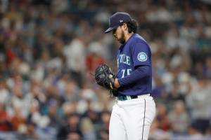 Seattle Mariners relief pitcher Andres Munoz walks off the field after giving up three runs and the lead to the Cleveland Guardians during the eighth inning of a baseball game, Saturday, Aug. 27, 2022, in Seattle. (AP Photo/John Froschauer)
