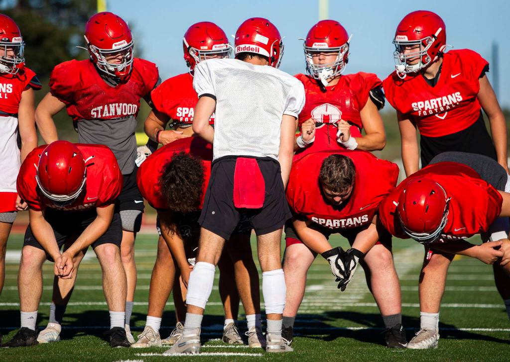 Stanwoods Michael Mascotti relays the next play to his teammates during practice Monday, Aug. 29, 2022 in Stanwood. (Olivia Vanni / The Herald)