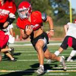 Stanwood’s Ryder Bumgarner runs the ball during football practice on Monday, Aug. 29, 2022 in Stanwood, Washington. (Olivia Vanni / The Herald)