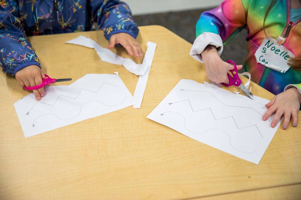 Kindergarteners do a paper cutting exercise on Aug. 26, near Everett. (Olivia Vanni / The Herald)