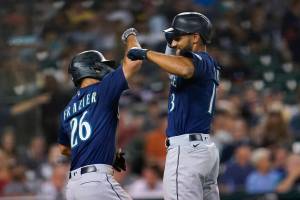 Seattle Mariners' Abraham Toro, right, celebrates his two-run home run with Adam Frazier (26) in the seventh inning of a baseball game against the Detroit Tigers in Detroit, Wednesday, Aug. 31, 2022. (AP Photo/Paul Sancya)