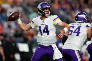 Minnesota Vikings quarterback Sean Mannion (14) throws against the Denver Broncos during the first half of an NFL preseason football game, Saturday, Aug. 27, 2022, in Denver. (AP Photo/Jack Dempsey)
