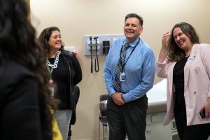 Meadowdale High School Principal Dave Shockley laughs while touring his school’s temporary space for the new school health center on Wednesday, Sep. 28, 2022, in Lynnwood, Washington. (Ryan Berry / The Herald)