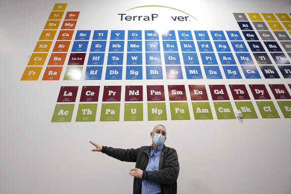 TerraPowers Michael Anderson, manager of test engineers and technicians, talks about the large periodic table on the wall overhead during a tour of the nuclear reactor development facility, on Jan. 13, in Everett. TerraPower plans to make its plant useful for todays energy grid with ever more renewable power. A salt heat battery will allow a nuclear plant to ramp up electricity production on demand, offsetting dips in electricity when the wind isnt blowing and sun isnt shining. (AP Photo / Elaine Thompson)