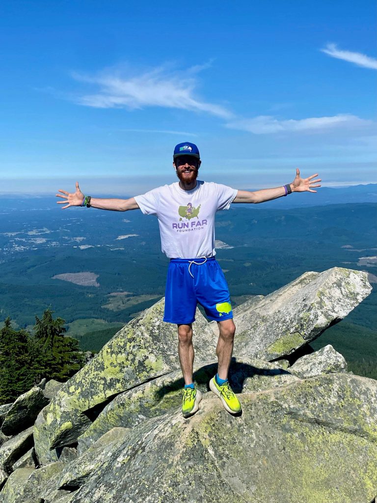 Greg Nance takes in the view on Tuesday, Aug. 23, 2022 after running up the summit of Mount Pilchuck. Nance, 33, holds the current record for the fastest sea-to-summit run up the mountain, from the Everett waterfront all the way to the top.