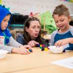 Alexander Williams, left, and Finn Botts, right, do a counting exercise with the help of Janet Chapman-Ruland on Friday, Aug. 26, 2022, near Everett, Washington. (Olivia Vanni / The Herald)