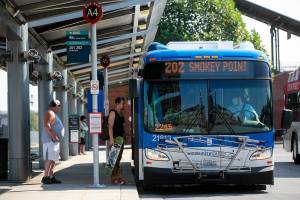 People board a Community Transit bus bound for Smokey Point Thursday, Sep. 1, 2022, at Everett Station in Everett, Washington. Thursday marked the first day people 18 and under can ride Community Transit routes for free. (Ryan Berry / The Herald)
