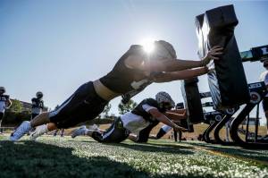 Glacier Peak’s Joe Johnson, front, pushes the sled during practice Thursday afternoon at Glacier Peak High School in Snohomish, Washington on August 25, 2022.  (Kevin Clark / The Herald)