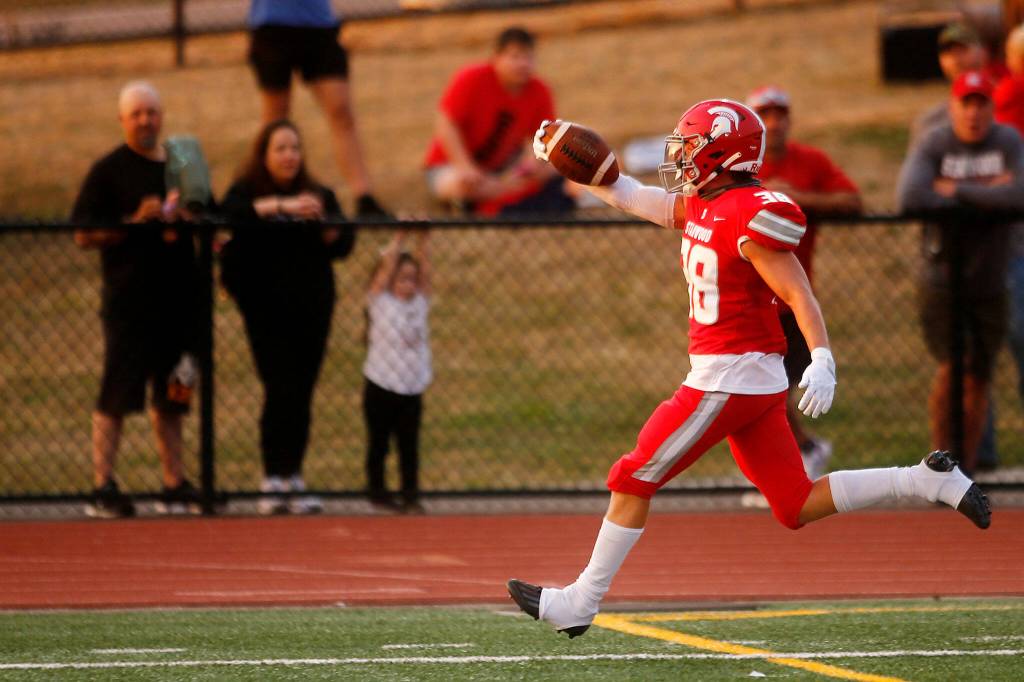 Stanwoods Carson Beckt celebrates after scoring the first touchdown of the season against Lakewood on Friday, Sep. 2, 2022, at Lakewood High School in Arlington, Washington. (Ryan Berry / The Herald)