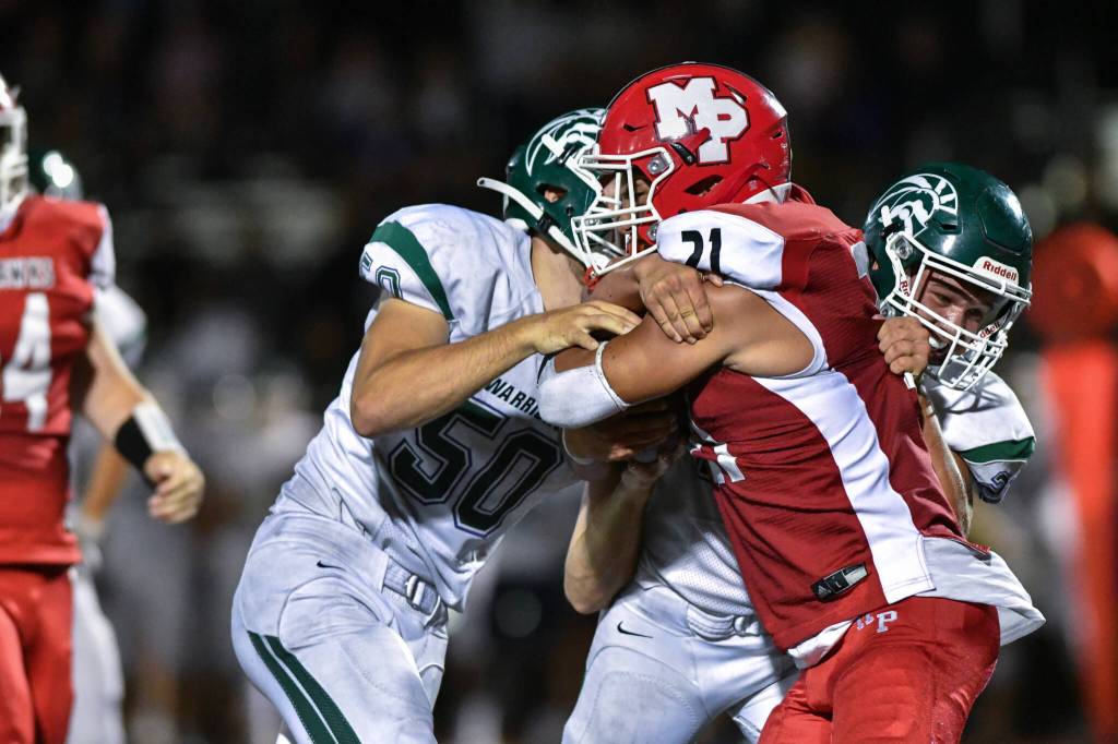 Edmonds-Woodway defenders gang up to tackle Marysville Pilchucks Kenai Sinaphet (21) during a game on Friday, Sept. 2, 2022, at Marysville Pilchuck High School. (John Gardner/Pro Action Image)