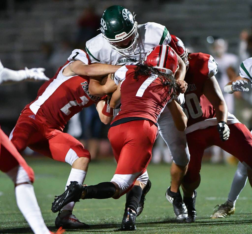 Marysville Pilchucks Lucian Curtis (2), Miguel Chavez (1) and Tayden Olson (30) work together to bring down Edmonds-Woodways Liam Fitting during a game on Friday, Sept. 2, 2022, at Marysville Pilchuck High School. (John Gardner/Pro Action Image)