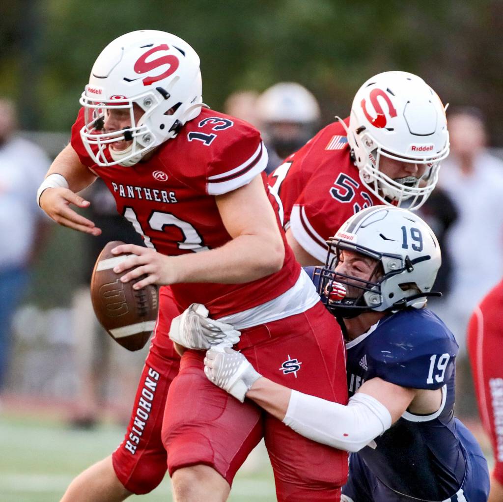 Snohomishs Kale Hammer avoids a sack by Glacier Peaks Will Jenkins Friday night at Snohomish High School in Snohomish, Washington on September 2, 2022. Glacier Peak led 28-0 at the half. (Kevin Clark / The Herald)
