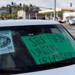 Signs decorate a windshield Monday morning during a sip in at Starbucks for union solidarity in Everett. (Kevin Clark / The Herald)