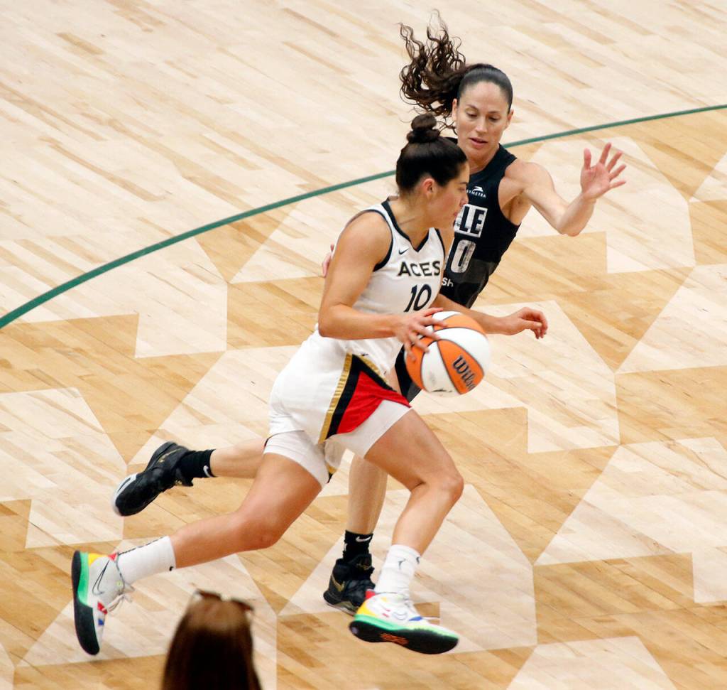 The Las Vegas Aces Kelsey Plum drives on Sue Bird during a WNBA playoff game against the Seattle Storm on Sunday, Sep. 4, 2022, at Climate Pledge Arena in Seattle, Washington. (Ryan Berry / The Herald)