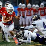Graham Kapowsin's Zack Lee escapes a tackle attempt by Lake Stevens during the 4A State Championship game Saturday evening at Mt.Tahoma High School in Tacoma on December 4, 2021. The Viking lost 44-7. (Kevin Clark / The Herald)