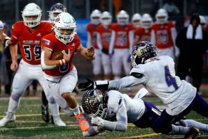 Graham Kapowsin's Zack Lee escapes a tackle attempt by Lake Stevens during the 4A State Championship game Saturday evening at Mt.Tahoma High School in Tacoma on December 4, 2021. The Viking lost 44-7. (Kevin Clark / The Herald)