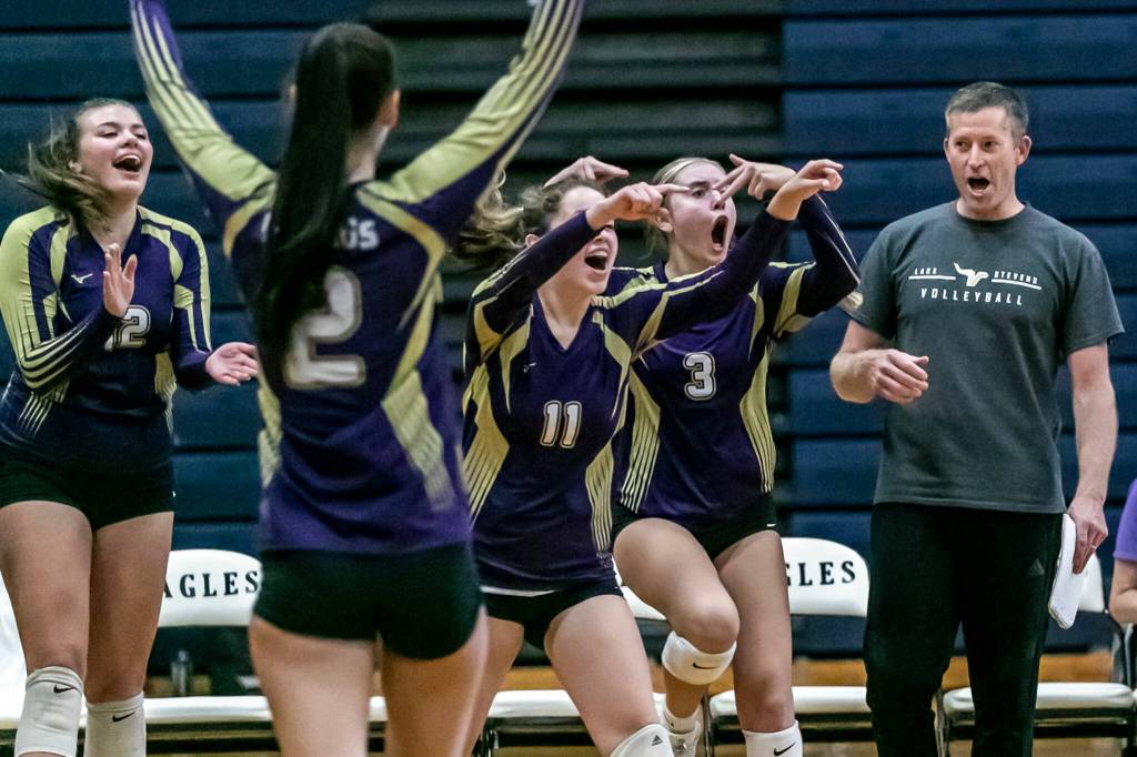 The Lake Stevens bench cheer for the start of a timeout by the Eagles in the second set Tuesday evening at Arlington High School in Arlington, Washington on September 6, 2022. The Vikings won the straight sets. (Kevin Clark / The Herald)