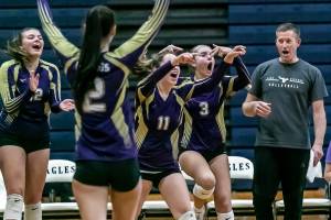 The Lake Stevens bench cheer for the start of a timeout by the Eagles in the second set Tuesday evening at Arlington High School in Arlington, Washington on September 6, 2022.   (Kevin Clark / The Herald)