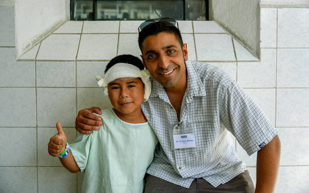 Dr. Prabhat Bhama with a patient in Guatemala after ear reconstructive surgery in 2016. (HUGS photo)
