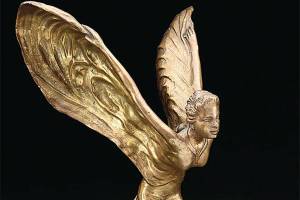 Photo Caption: The Spirit of Ecstasy, nicknamed the Flying Lady or Silver Lady, has decorated Rolls-Royce cars since 1911. This figure is a brass reproduction.