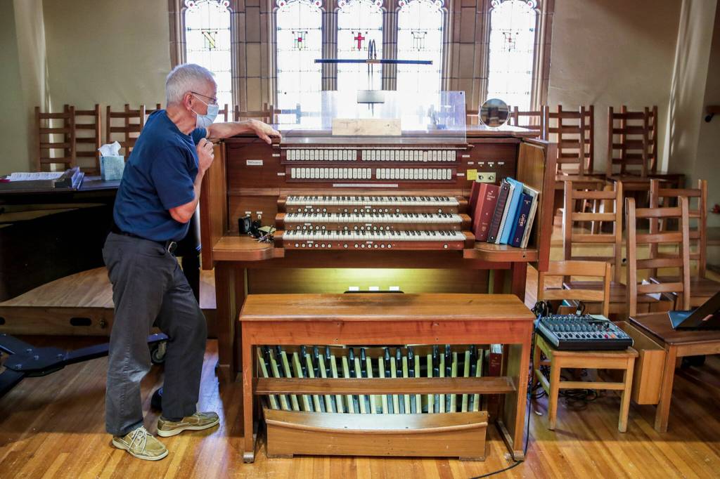 David Spring explains possible plans for the churchs organ Wednesday afternoon at Trinity Episcopal in Everett. (Kevin Clark / The Herald)