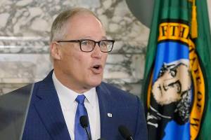 Washington Gov. Jay Inslee speaks as he gives his annual State of the State address, Tuesday, Jan. 11, 2022, at the Capitol in Olympia, Wash. Due to cautions against COVID-19, Inslee gave his speech in the State Reception Room and it was shown by streaming video to lawmakers meeting remotely. (AP Photo/Ted S. Warren)