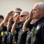 South County firefighters salute during the presentation of the colors during a ceremony to commemorate the 21st anniversary of the September 11 terrorist attacks on the U.S. on Sep. 11, 2022, outside South County Fire Station 17 in downtown Edmonds, Washington. (Ryan Berry / The Herald)